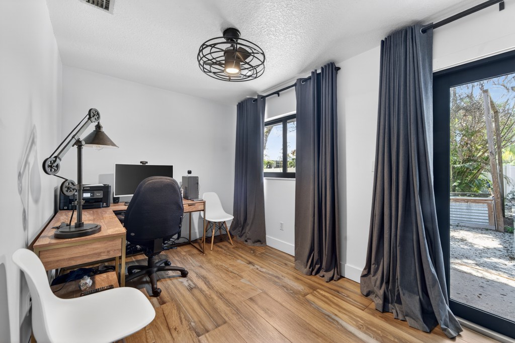 Home office with wood desks and blackout drapes, Vero Beach listing photography