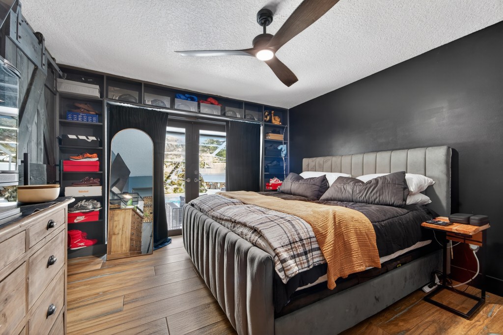 Bedroom with black accent wall and custom closet built-ins, Vero Beach real estate photos