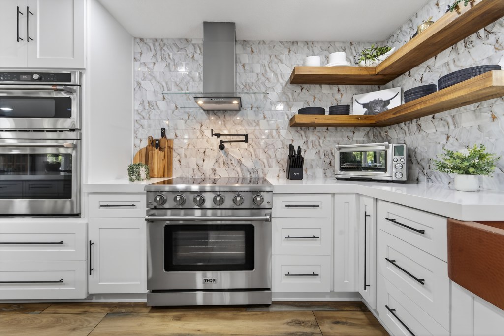 Thor professional range with pot filler and floating shelves in renovated Vero Beach kitchen