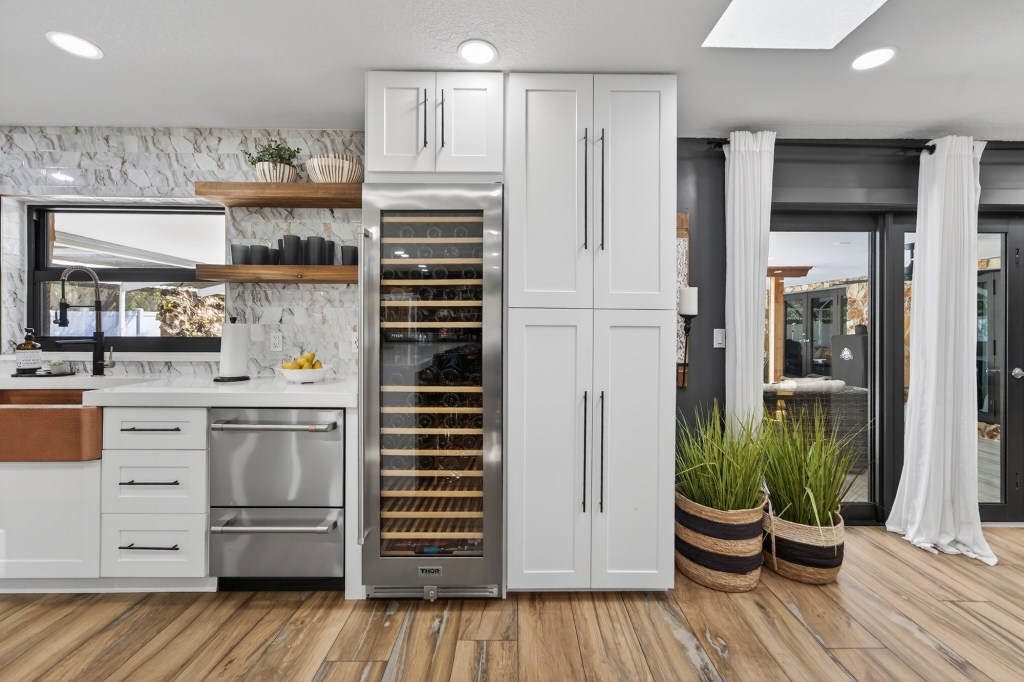 Wine column and pantry wall in renovated Vero Beach kitchen, real estate photography
